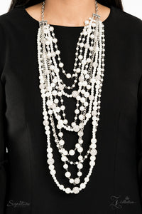 An elegant collection of timeless white pearls, shiny sections of silver chain, and bedazzling white rhinestone encrusted silver beads effortlessly cascade down the chest. The vintage inspired layers drape into breathtaking rows of radiance, resulting in an irresistible collision of romance. Features an adjustable clasp closure.