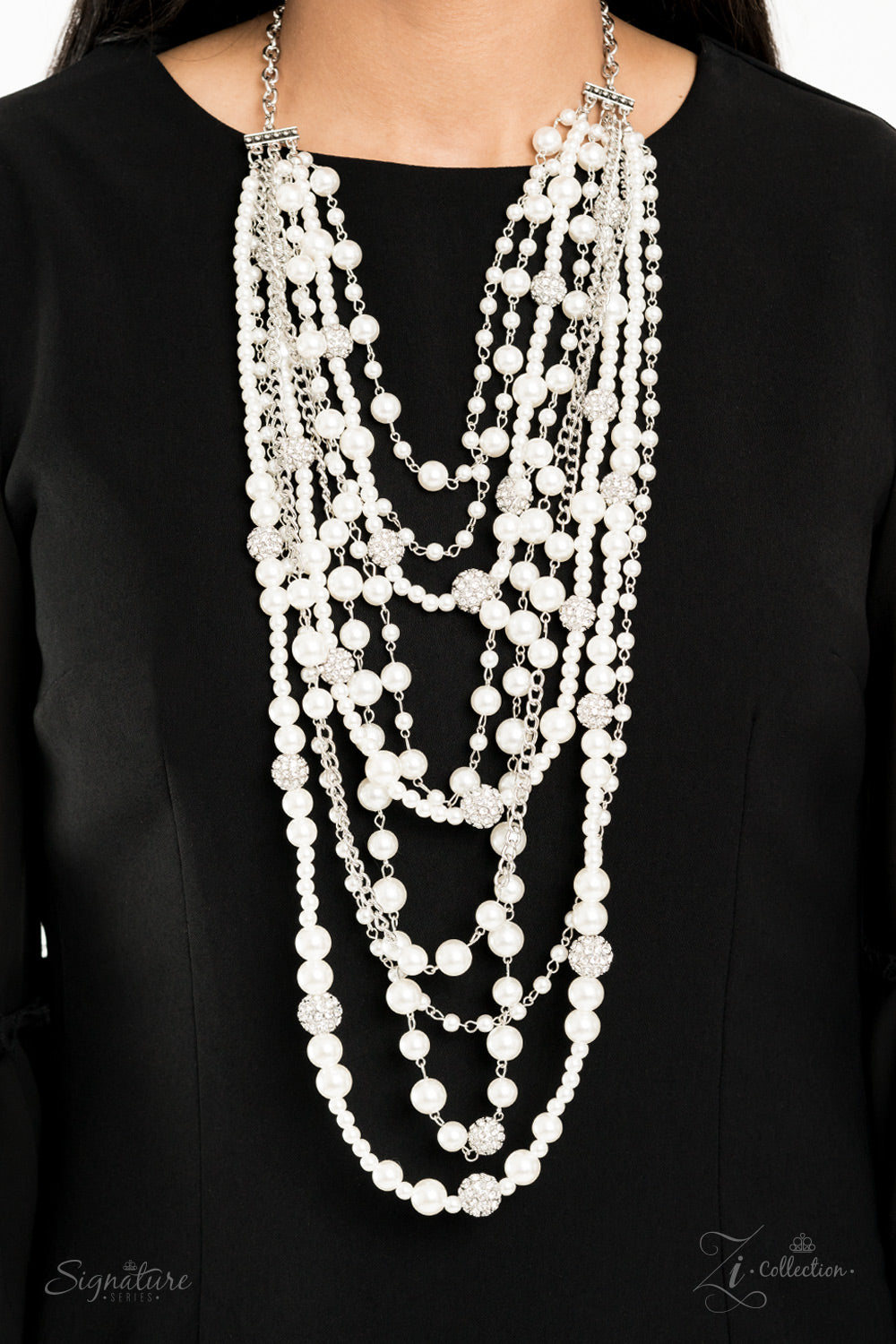 An elegant collection of timeless white pearls, shiny sections of silver chain, and bedazzling white rhinestone encrusted silver beads effortlessly cascade down the chest. The vintage inspired layers drape into breathtaking rows of radiance, resulting in an irresistible collision of romance. Features an adjustable clasp closure.
