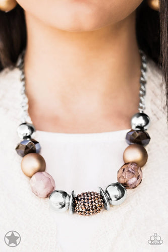 Warm beads in shades of brown and copper with reflective faceted edges and varying glazed finishes are offset by two shiny silver beads. An oblong bead studded with copper-toned rhinestones adds a dramatic accent. Features an adjustable clasp closure.  Sold as one individual blockbuster necklace. Includes a matching set of earrings.