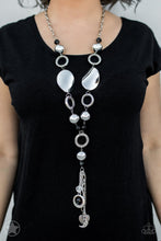 Load image into Gallery viewer, Long chain of black crystalized beads, curved plates of silver with a pearly finish, and chunky silver rings lead down to a tassel of chains and charms, including a crescent moon and a heart.  Sold as one individual blockbuster necklace with matching earrings.
