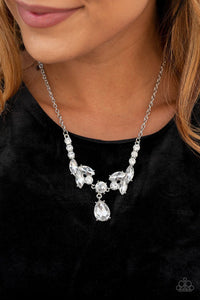 Tiers of white rhinestone encrusted silver frames delicately link below the collar, giving way to an oversized white teardrop rhinestone pendant for a timeless finish. Features an adjustable clasp closure. Includes one pair of matching earrings.